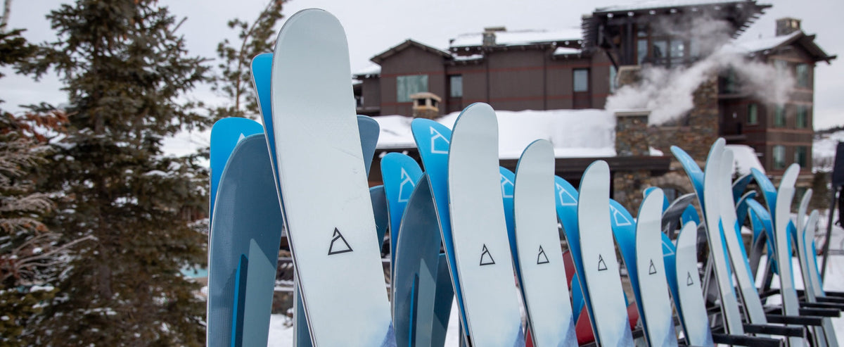 Renoun skis on a ski rack in size order