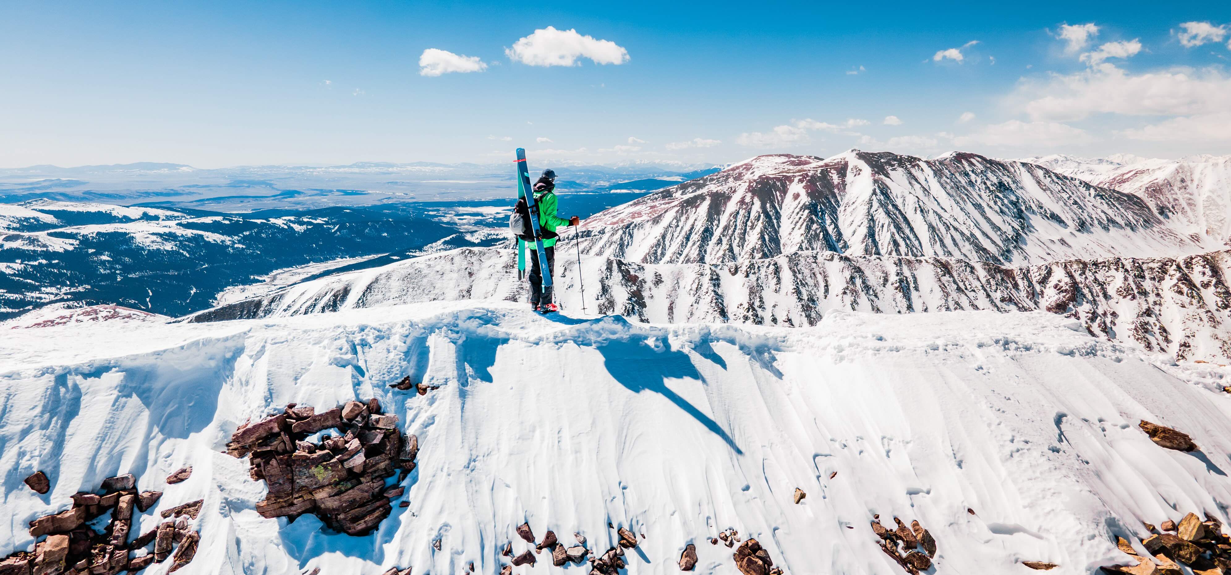 Reilly Kazcmarek at the top of a 14er in CO during the summer, getting ready to ski