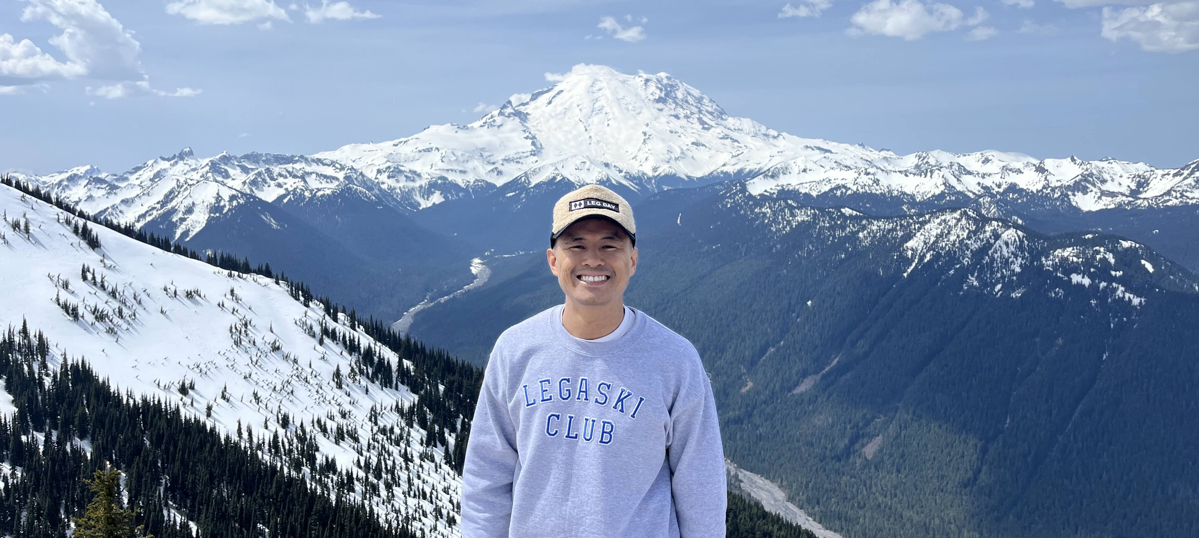 Greg Louie, The Ski PT in front of a mountain view