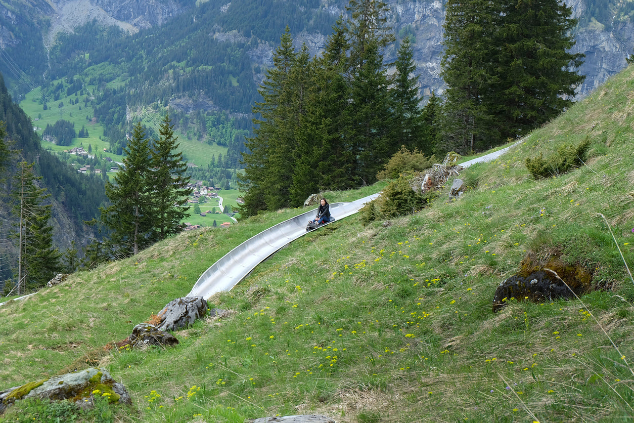 Woman riding alpine slide in the mountains